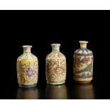 Arte Islamica A group of three pottery bottle vases painted with floral decoration Iran, 19th-20th