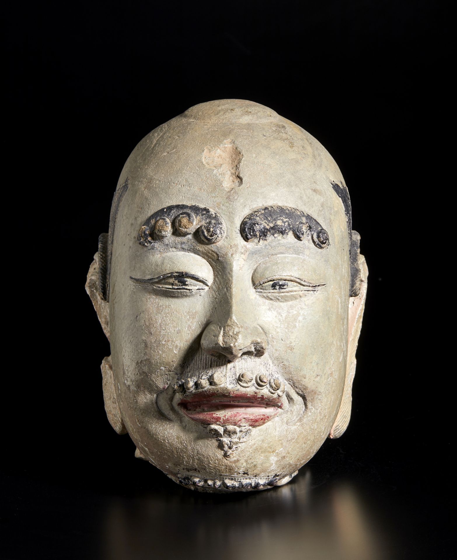 Arte Cinese An impressive polychrome sandstone head of a LuohanChina, Ming dynasty or earlier.