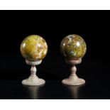 . A pair of marble spheres on their base.