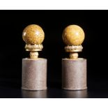 . A pair of yellow stone spheres mounted on wooden baseItaly, 20th century.