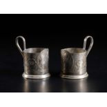 . A pair of metal cup holder depicting the artificial satellite Sputnik 1 launched into orbit on oc