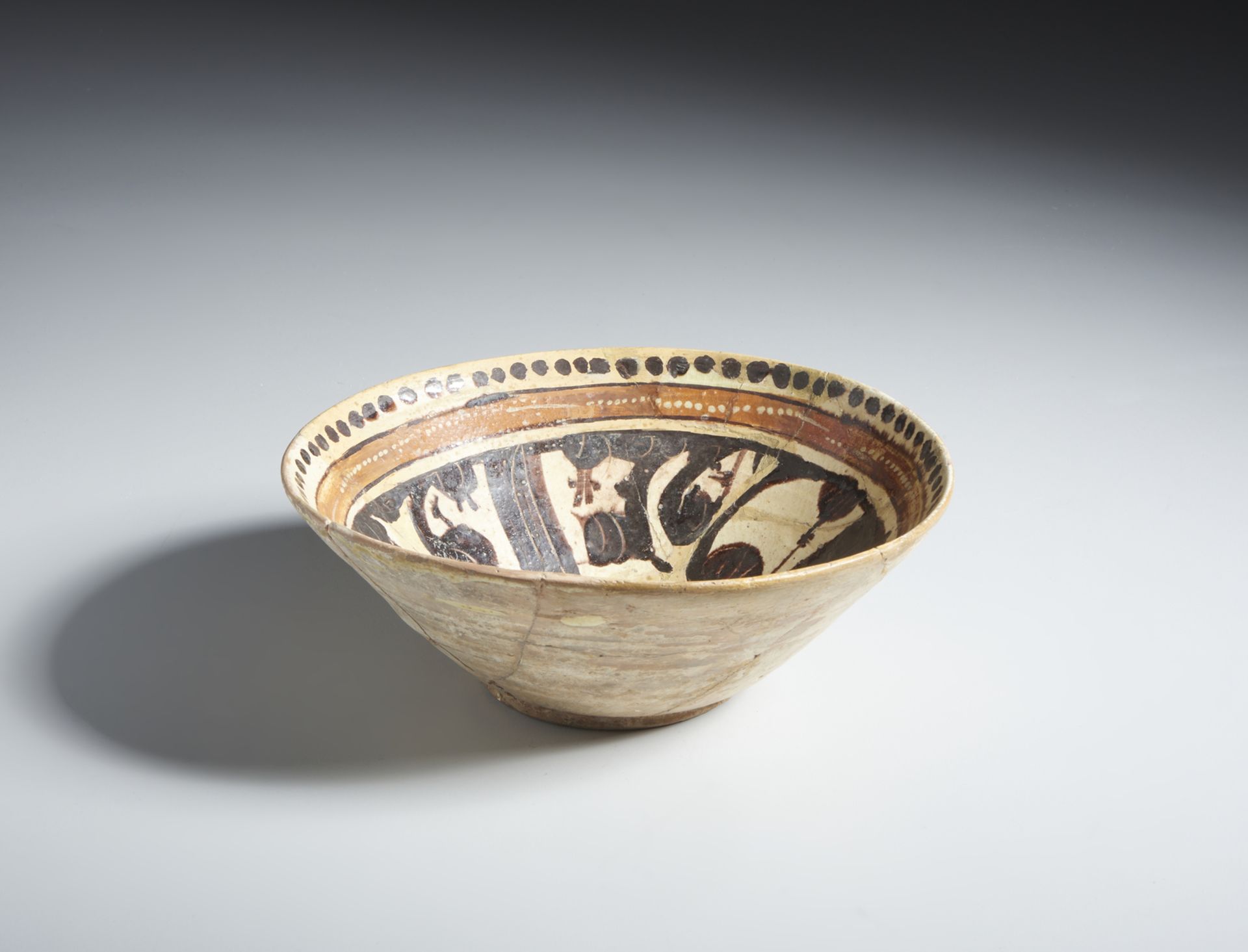 A terracotta slip painted calligraphic bowl Samanid Eastern Persia, 10th century Restored. Cm 22,