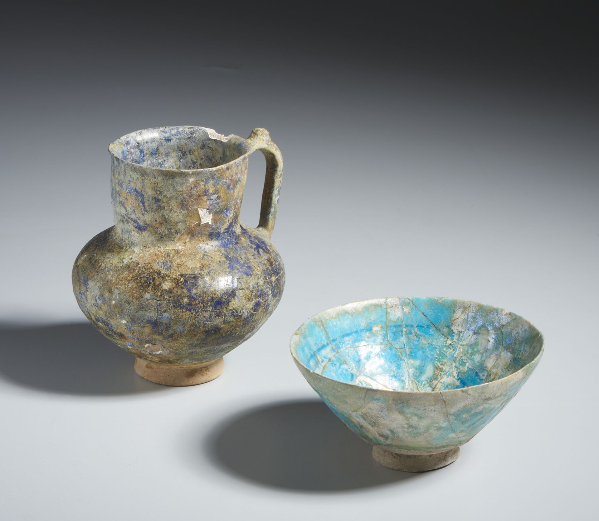 Pottery glazed bowl and jug Iran, 12th -13th century Frit body; one with a high cylindrical neck and
