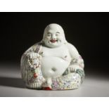 A porcelain enameled Budai figure China, Republic Period, early 20th century Cm 26,00 x 26,00