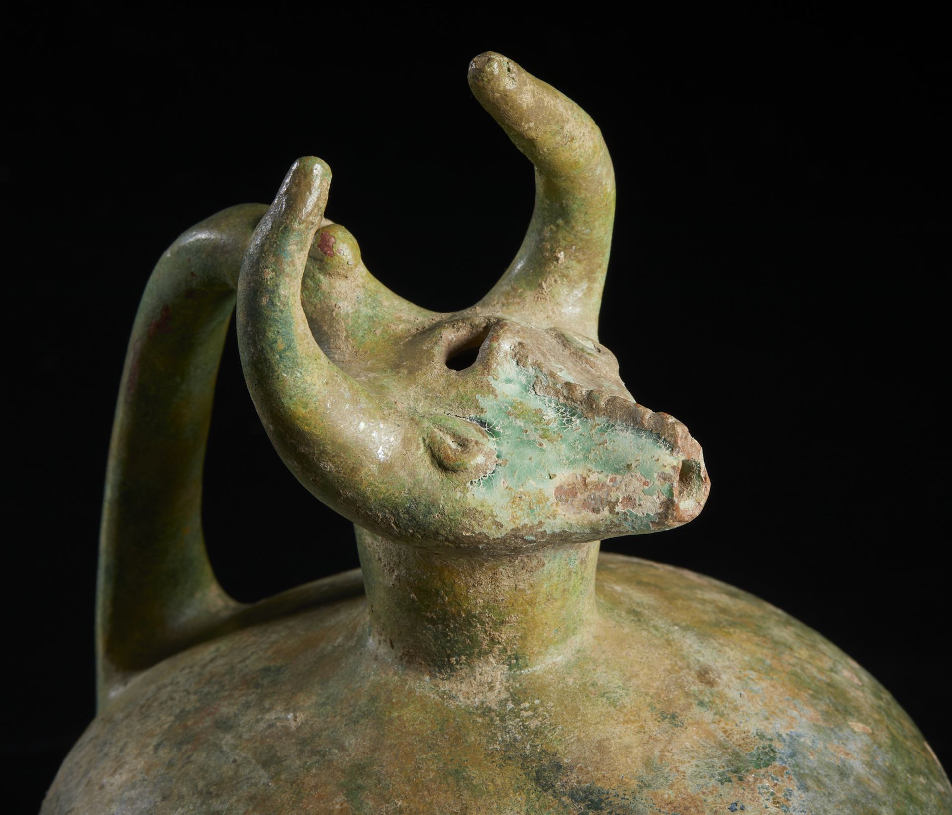 A bull (gav) headed green glazed pottery jug Iran, 12th century Of moulded fritware with a - Image 5 of 6