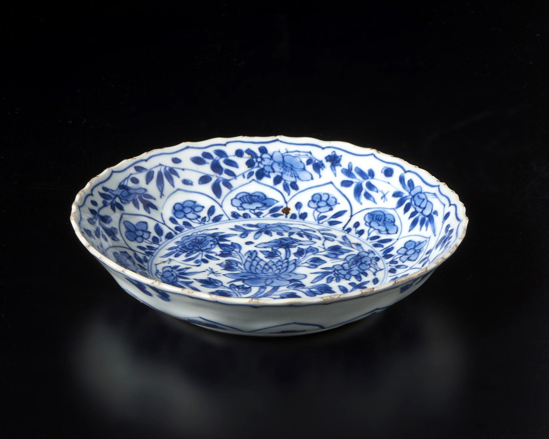 A blue and white porcelain dish China, Qing, Kangxi mark and perioddecorated with floral scrolls, - Image 2 of 3