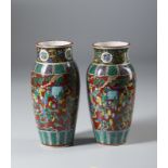 A pair of Kutani vases enameled with characters over brown ground and bearing a four character