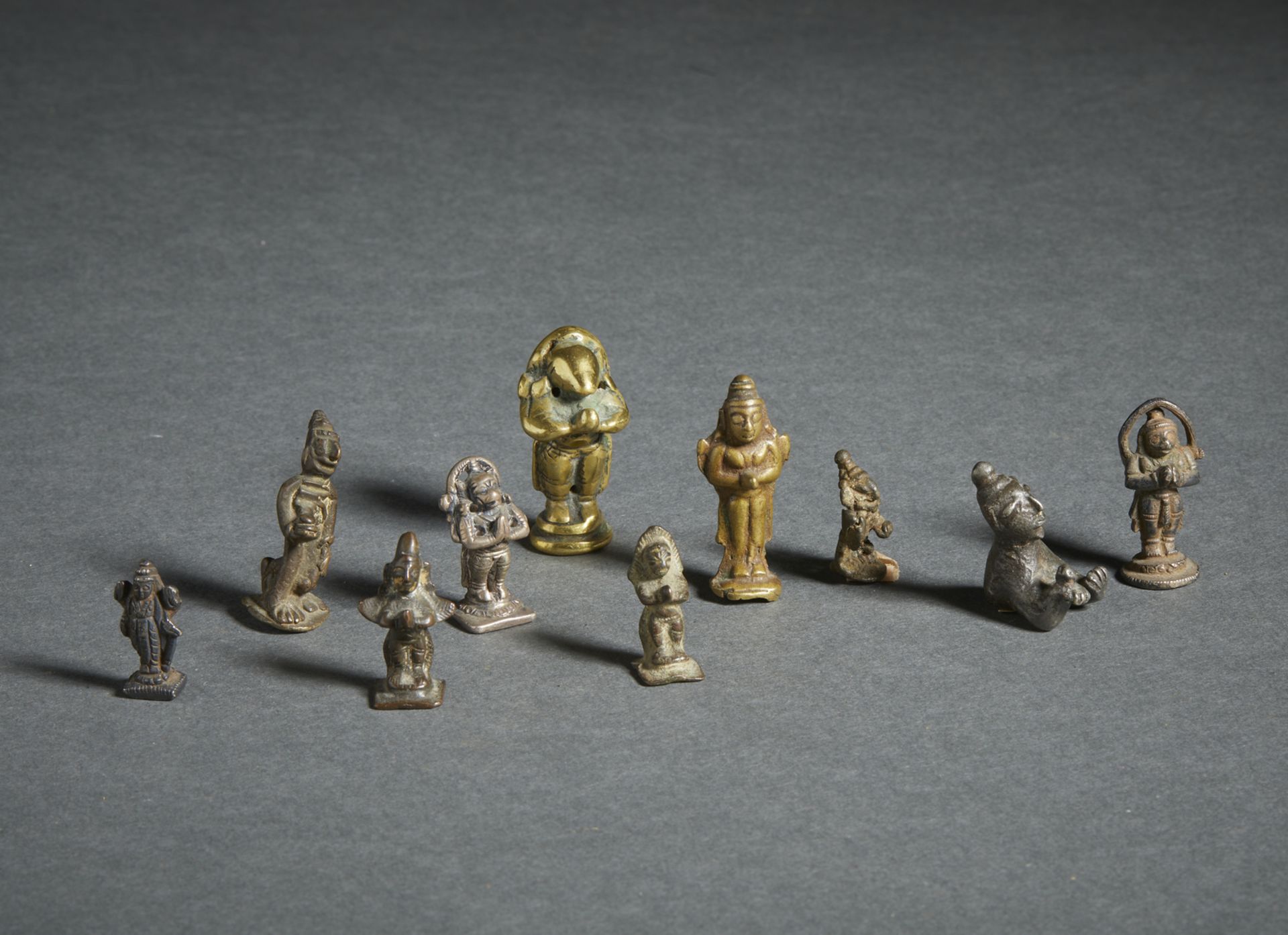 A group of 10 miniature devotional bronze figures India, 19th century The size shown refers to the