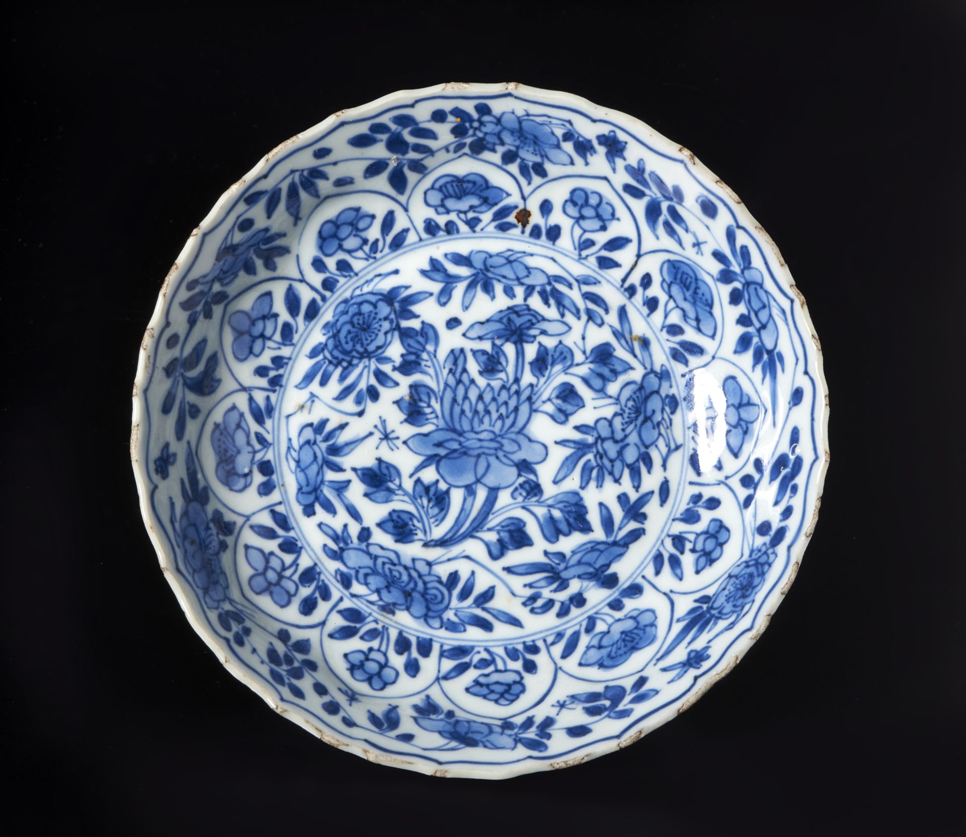 A blue and white porcelain dish China, Qing, Kangxi mark and perioddecorated with floral scrolls,