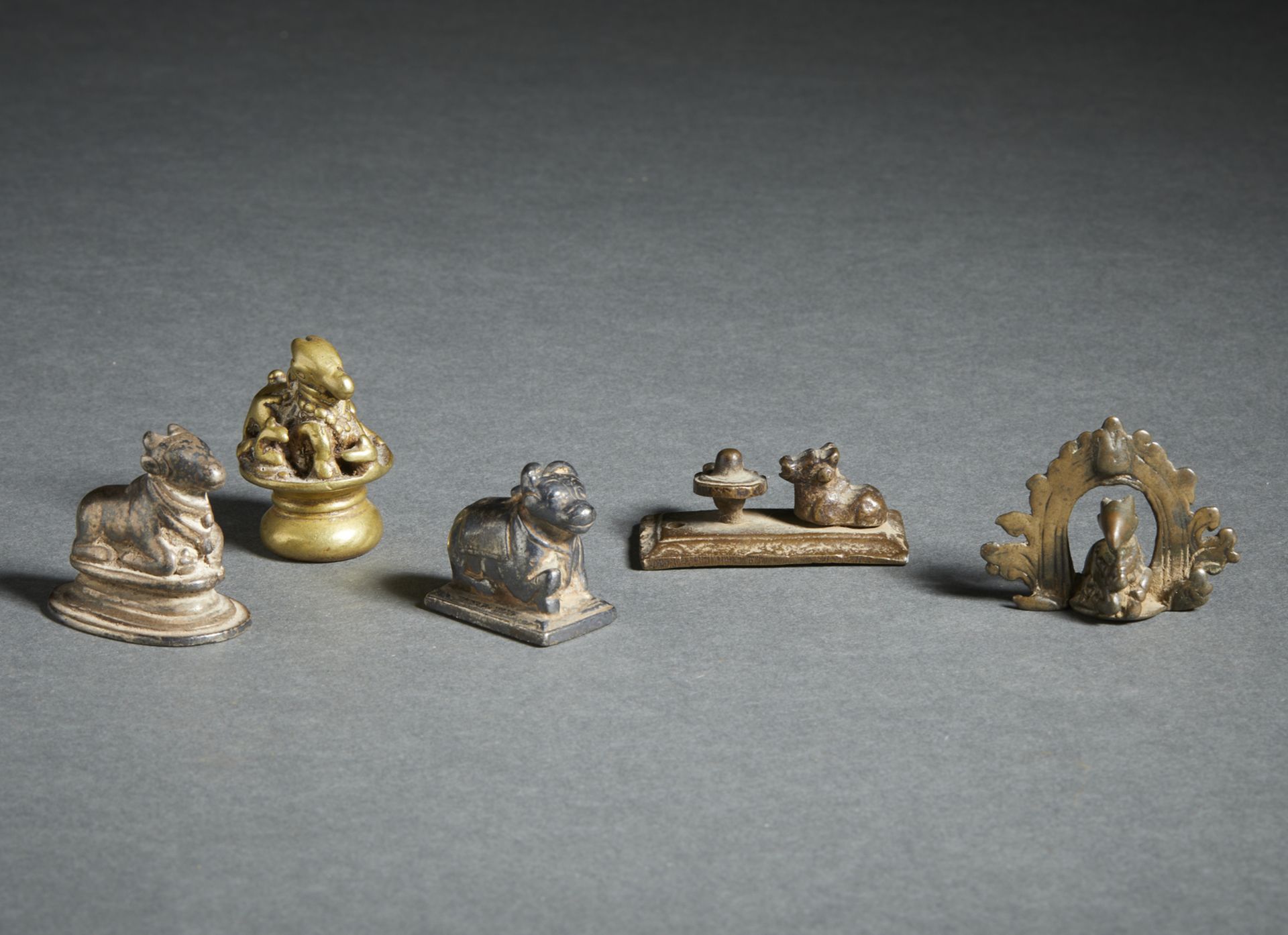 A group of 5 copper alloy figures of recumbent Nandi Central and Southern India, 18th-19th century