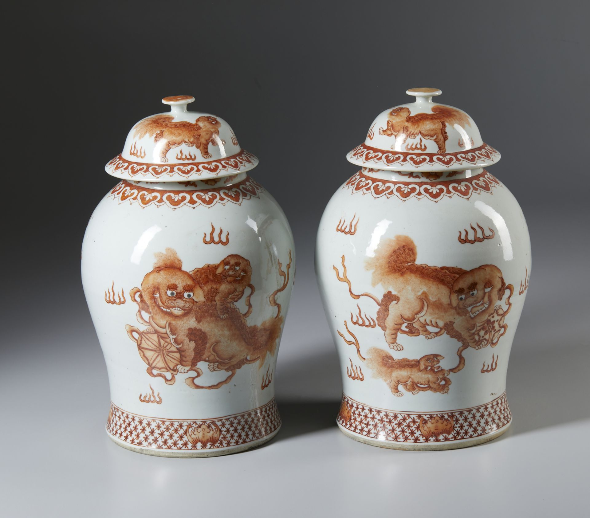 A fine and impressive pair of porcelain iron red “Pho dogs” storage jars . China, Qing, 19th century