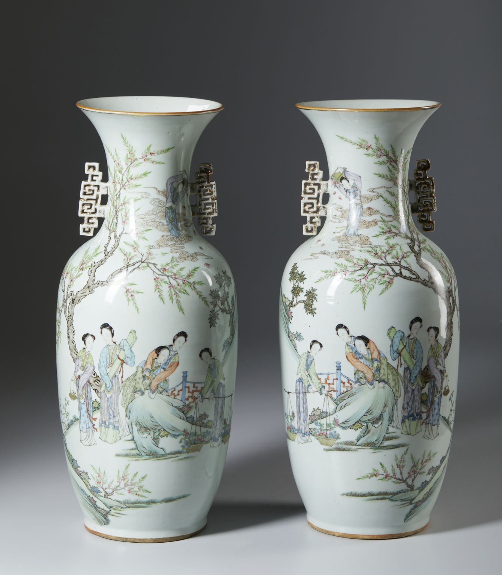 A pair of large porcelain balauster vases with pierced gilded handles and iron red seal on the base.