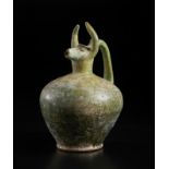 A bull (gav) headed green glazed pottery jug Iran, 12th century Of moulded fritware with a