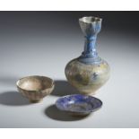 A group of 3 blue pottery vessels Iran, 13th century Fritbody, including: a moulded bottle covered