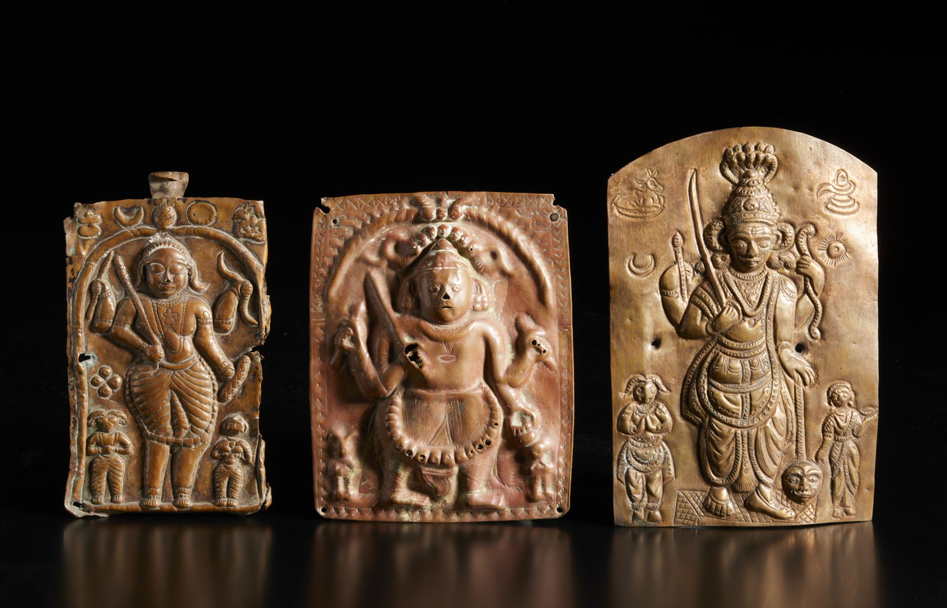 A group of three copper repoussè Virabhadra plaques India, 19th century The size shown refers to the