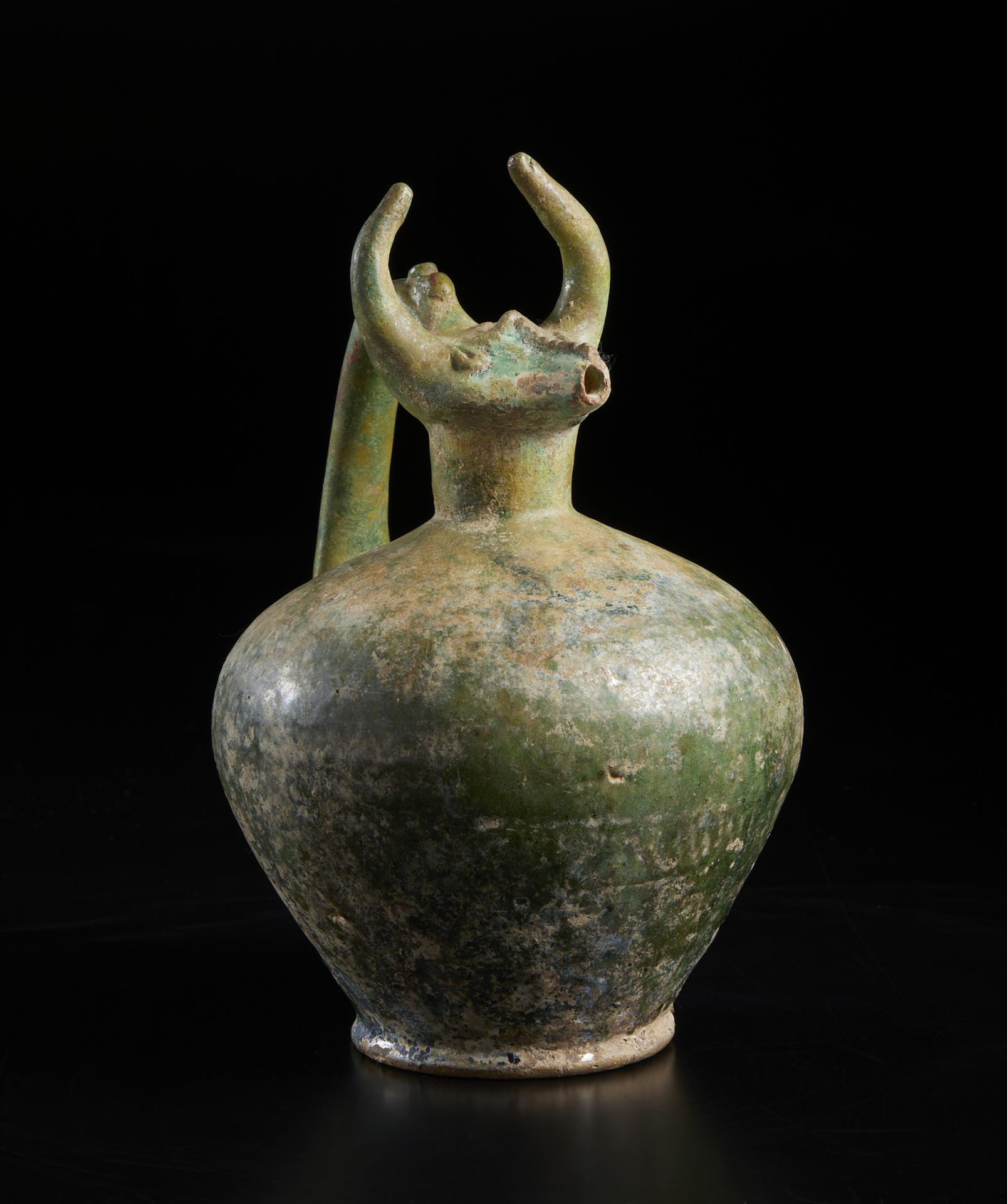 A bull (gav) headed green glazed pottery jug Iran, 12th century Of moulded fritware with a - Image 2 of 6