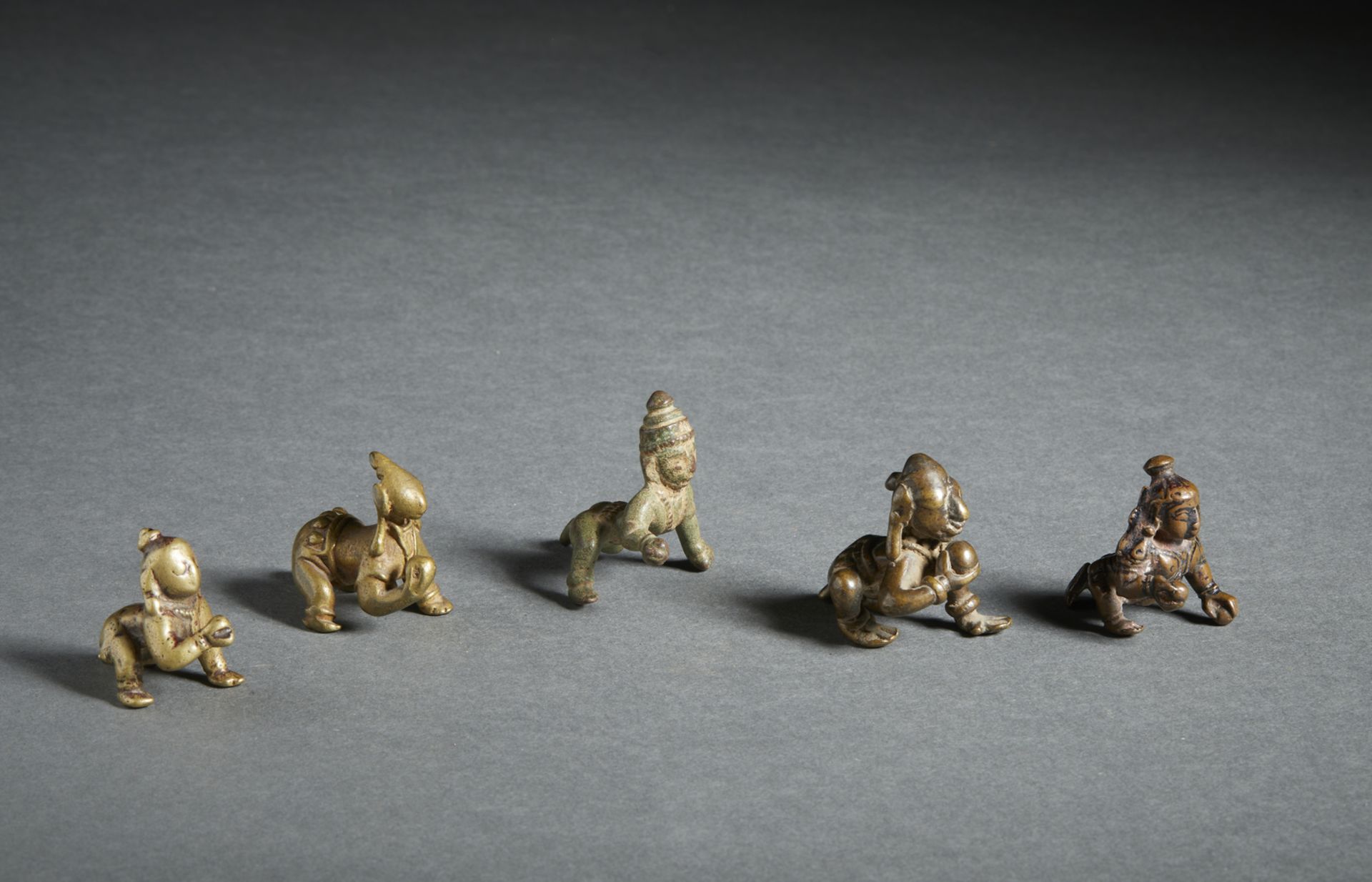 A group of five crawling copper alloy Balakrishna figures India, 18th-19th century The size shown