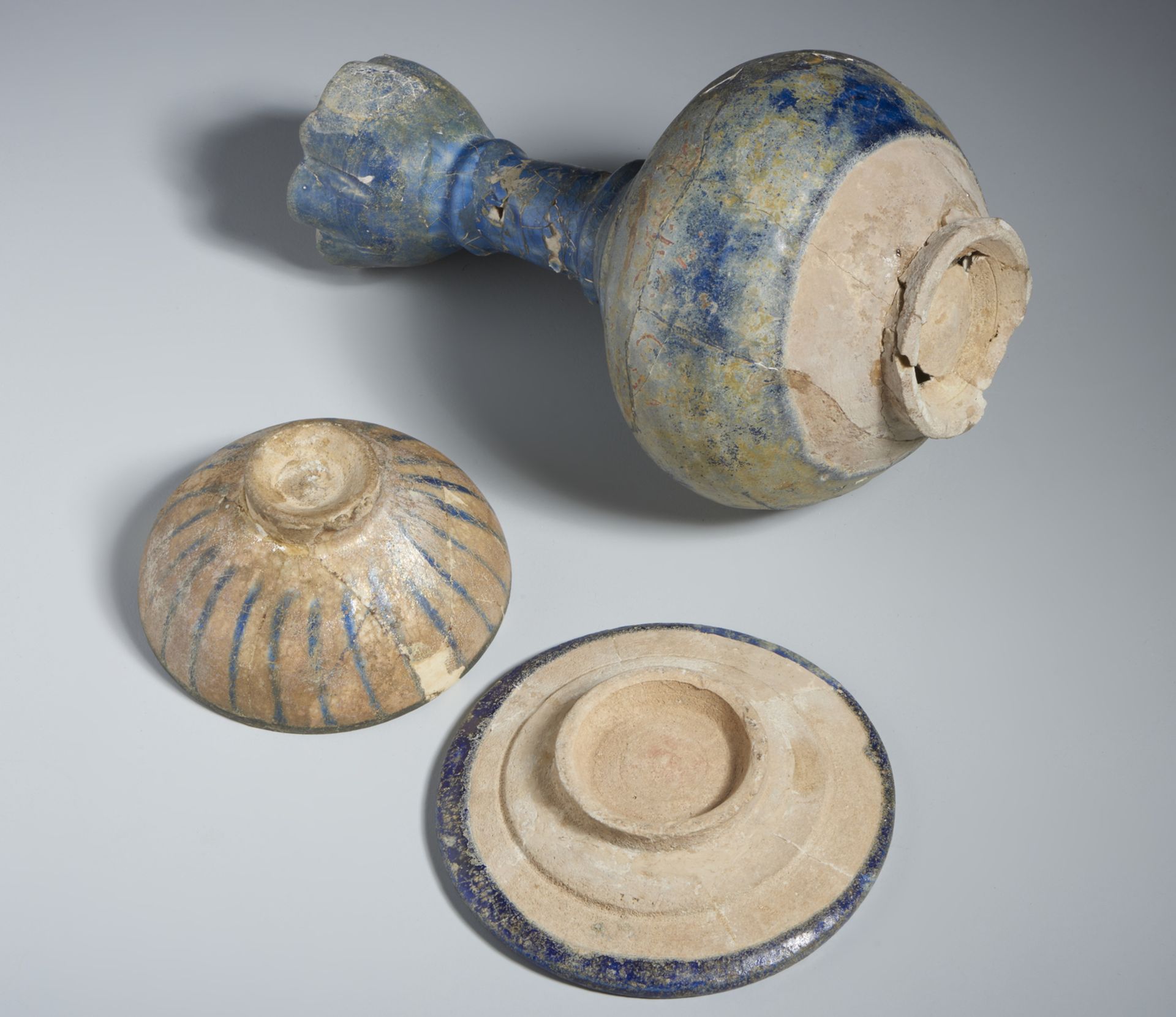 A group of 3 blue pottery vessels Iran, 13th century Fritbody, including: a moulded bottle covered - Image 3 of 3