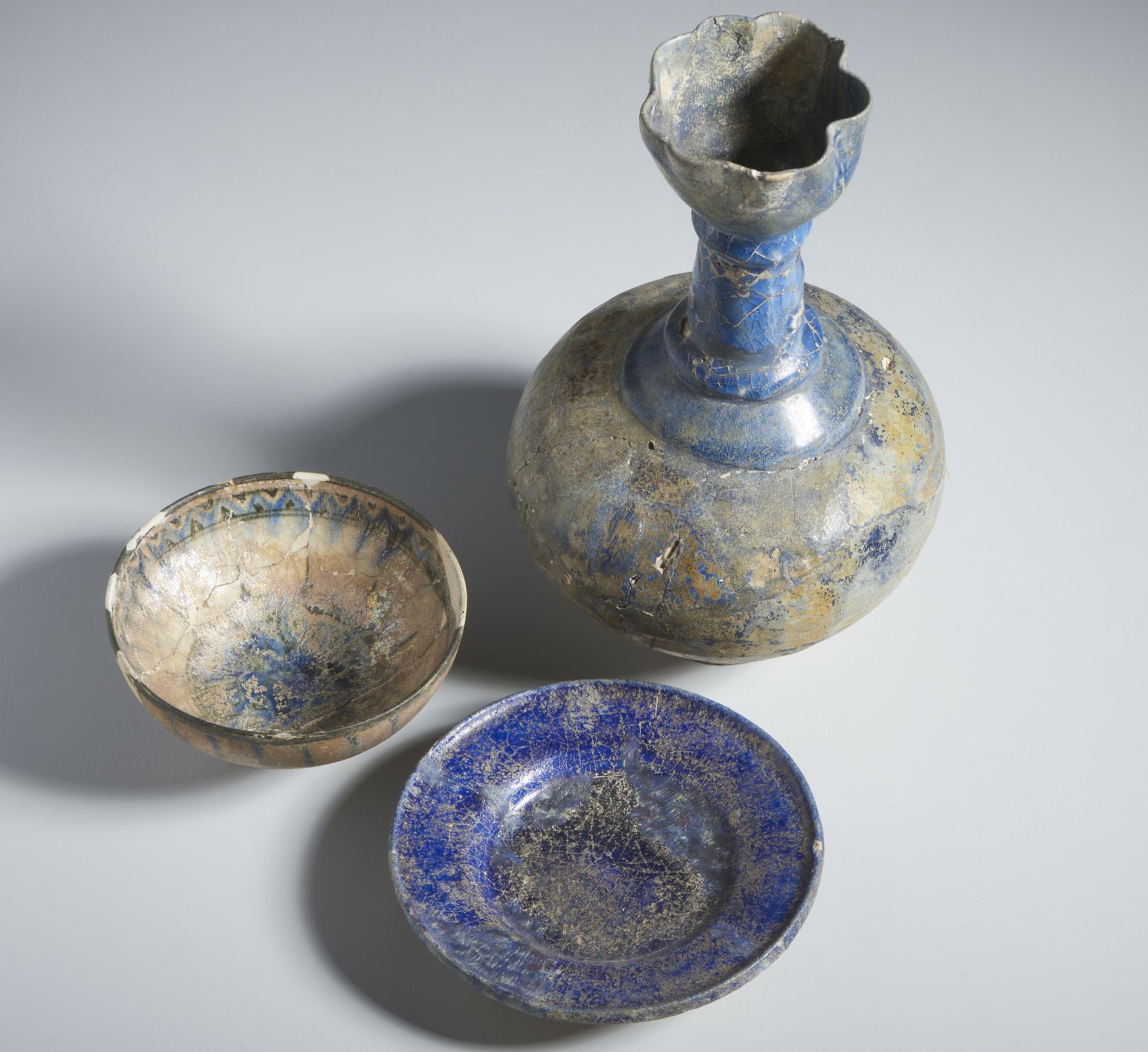 A group of 3 blue pottery vessels Iran, 13th century Fritbody, including: a moulded bottle covered - Image 2 of 3