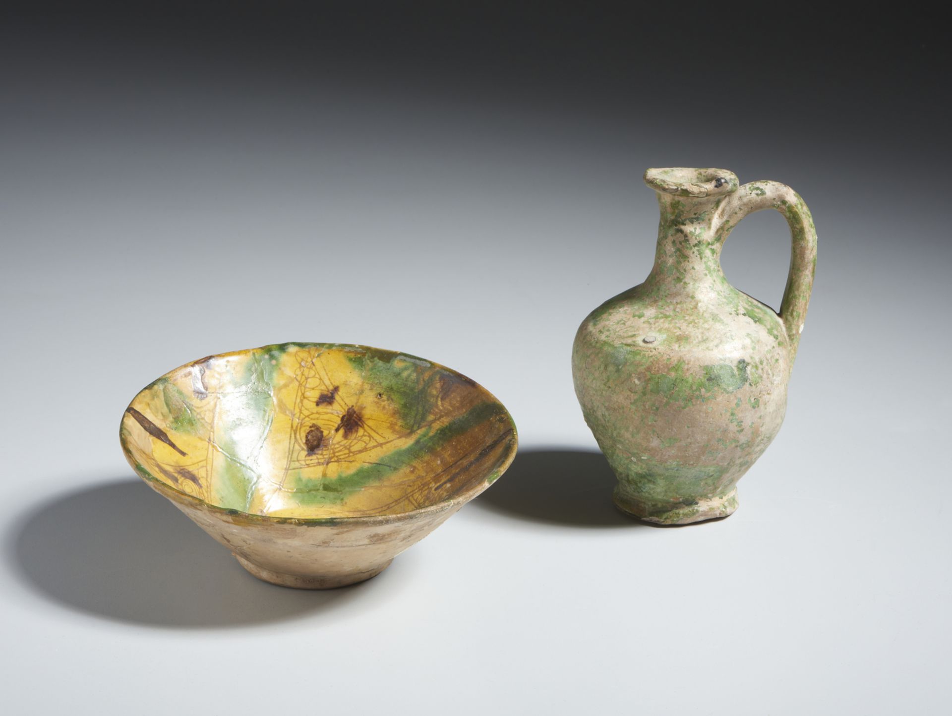 An early islamic green glazed jug and a splashed pottery bowl Mesopotamia and Eastern Iran, 8th