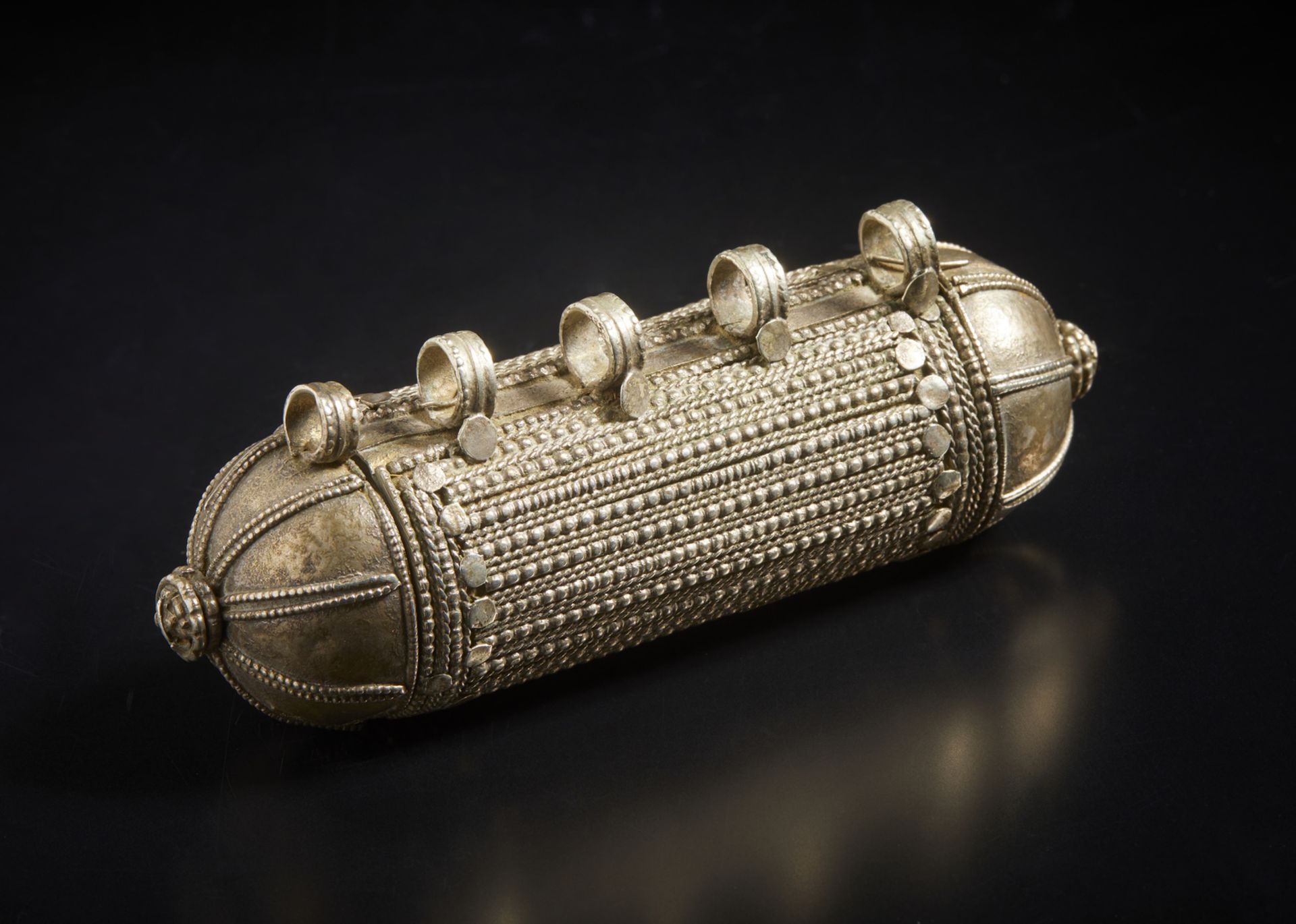 A large silver amulet Yemen, 19th century Cylindrical box with talismanic function, used to hold