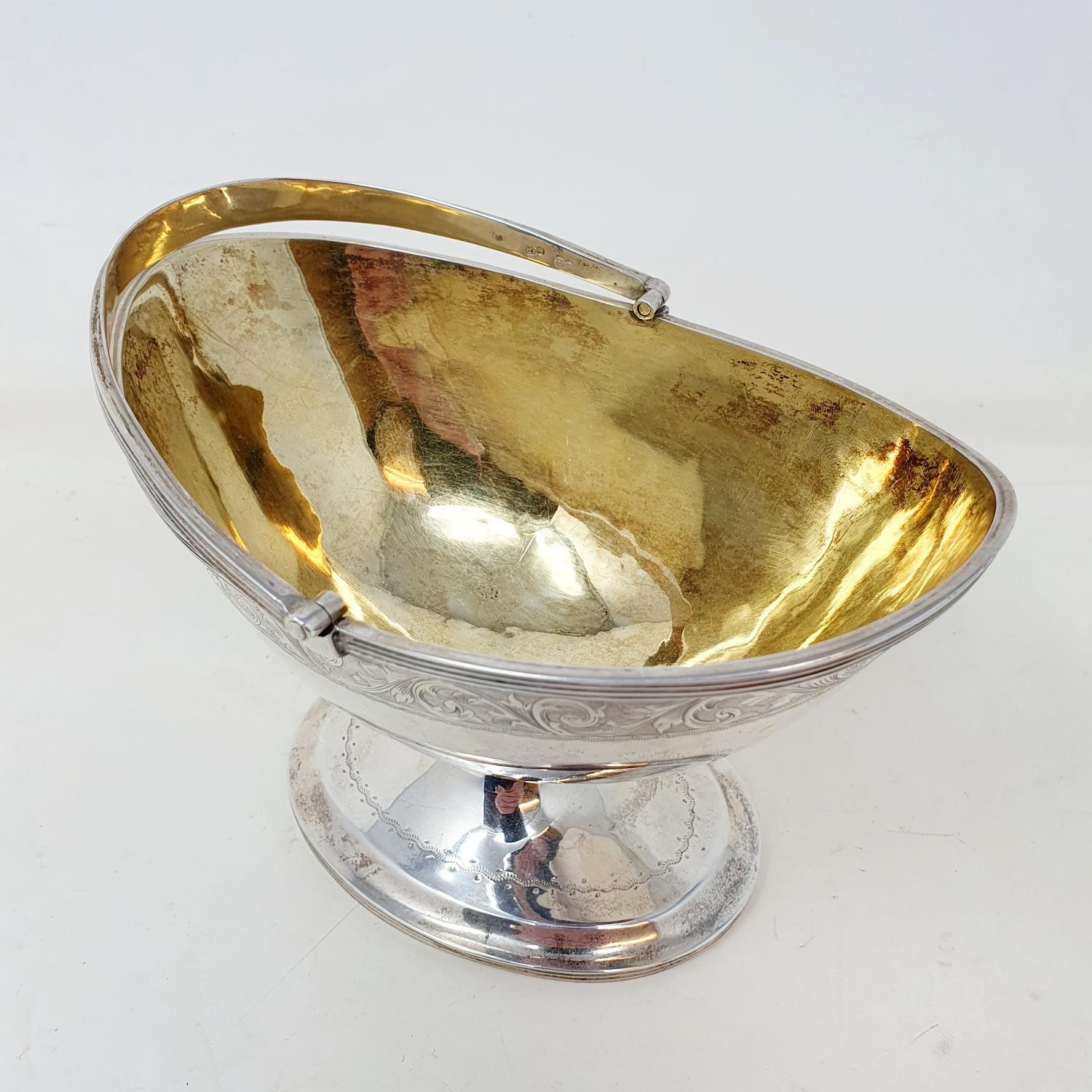 A Victorian silver sugar basket, with a swing handle and engraved decoration, on an oval pedestal - Image 3 of 4