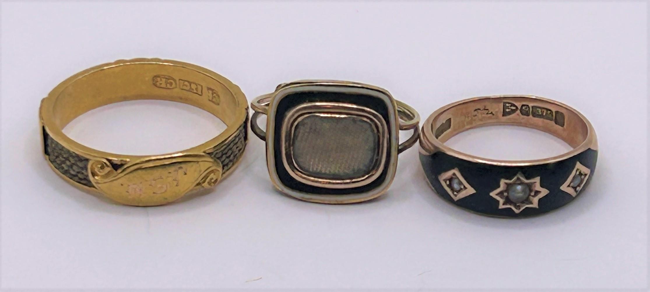 A gold blue and white enamel memorial ring, ring size L, and two others (3)