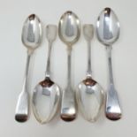 A George III silver fiddle pattern tablespoon, and four other tablespoons, various dates and