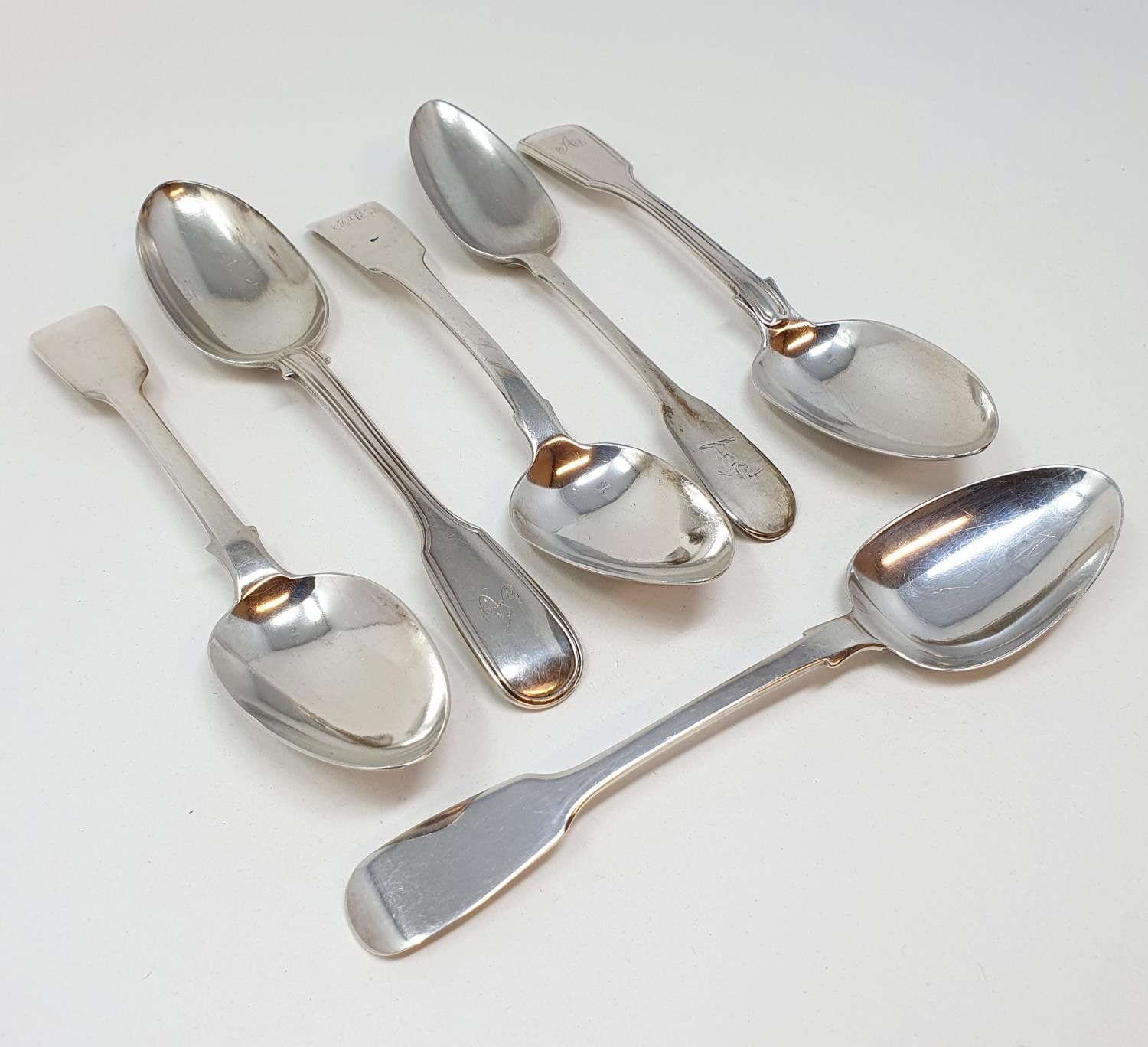 A pair of Victorian silver fiddle and thread pattern dessertspoons, and four other fiddle pattern