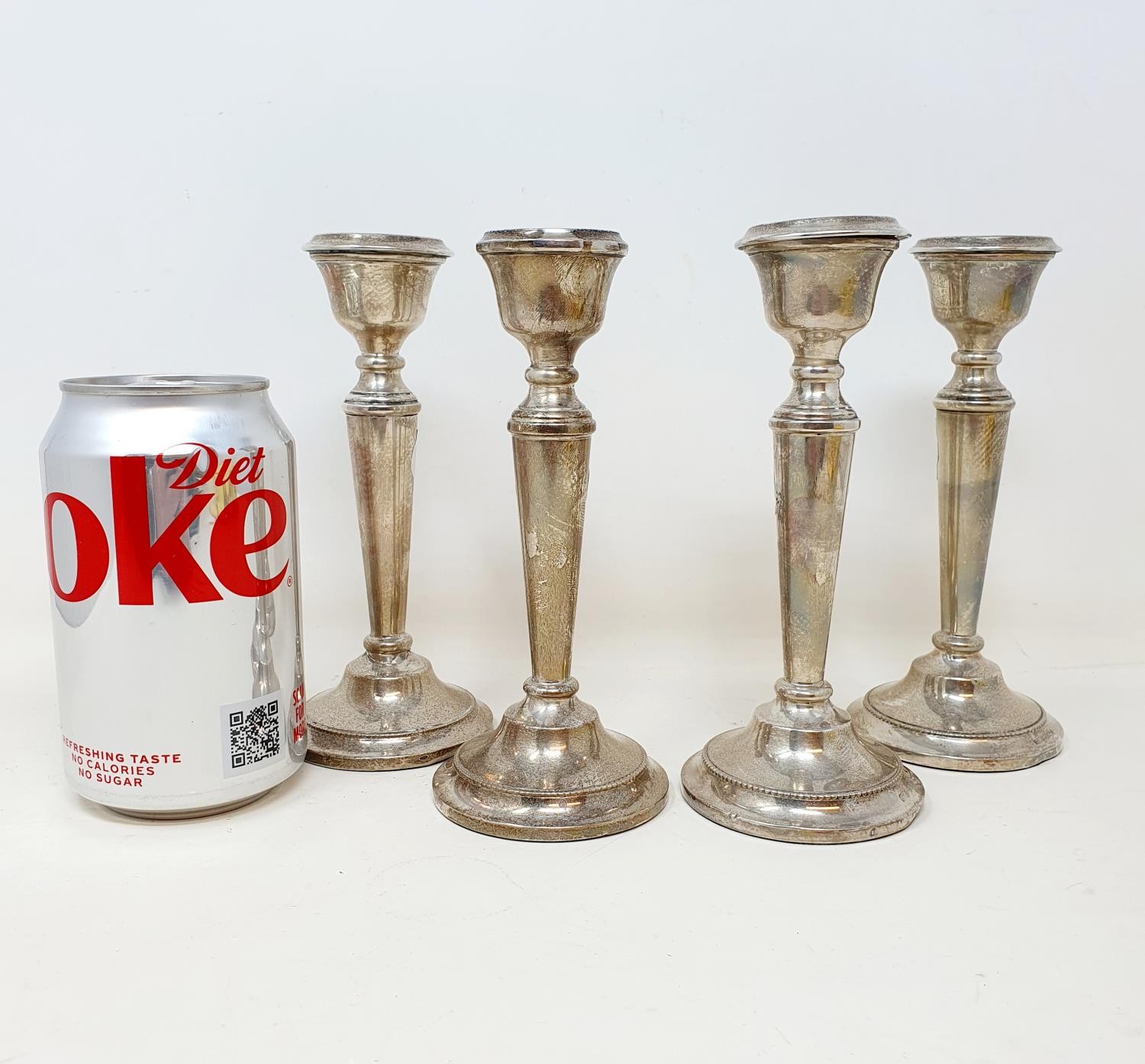 A set of George V silver candlesticks, Birmingham 1914, 15 cm high, bases filled (4)