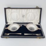 A pair of George V silver pickle bowls, in the form of quaiches, with glass liners and matching