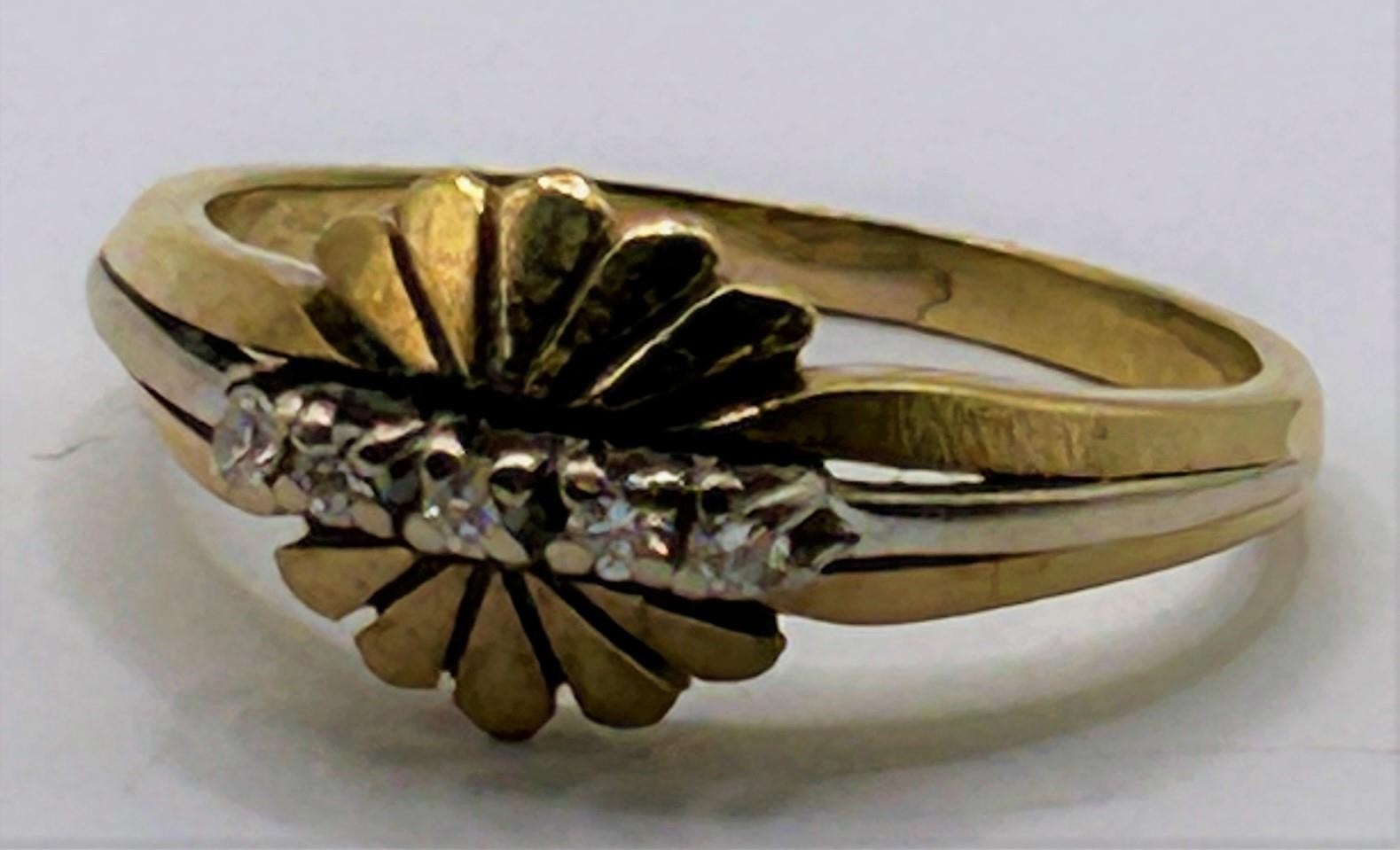 A yellow coloured metal and diamond ring, ring size L