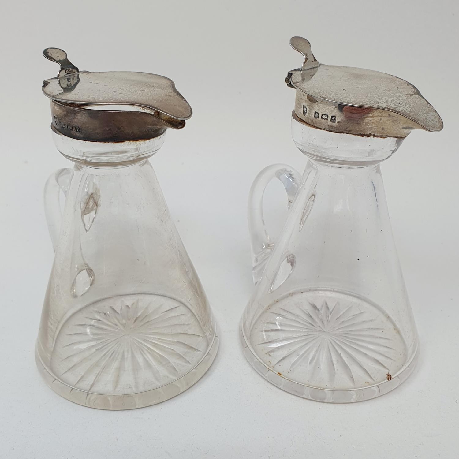 A pair of Edward VII glass and silver mounted whisky noggins, Birmingham 1905 (2) one hinge slightly