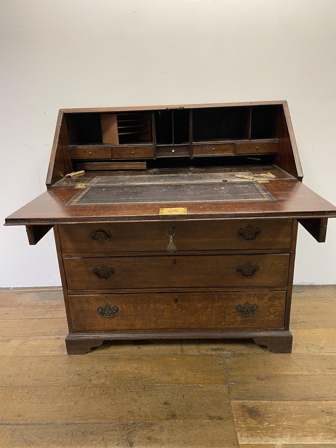 A George III oak bureau, the fall front to reveal a fitted interior, above four graduated drawers, - Image 4 of 9