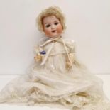 An Armand Marseille German bisque headed doll, No 990, composite body and millefiori glass closing