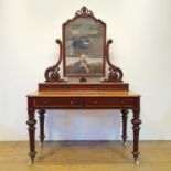 A Victorian mahogany dressing table, the mirror raised on pierced scroll carved supports above three