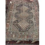 A Persian red ground carpet multiple borders, the centre with three lozenge shaped stepped