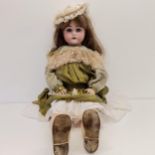 A German bisque headed doll, with a composite jointed body, millefiori closing eyes, 80 cm