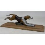 A cold painted bronze desk clip figure of a hound, on a wooden base, 28 cm wide Condition good, a