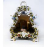 A Dresden porcelain strut mirror, decorated flowers, 48 x 35 cm