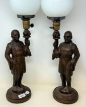 A pair of carved wood figural lamps, 60 cm high (2)