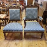 An early 20th century walnut framed armchair, and a matching nursing chair (2)