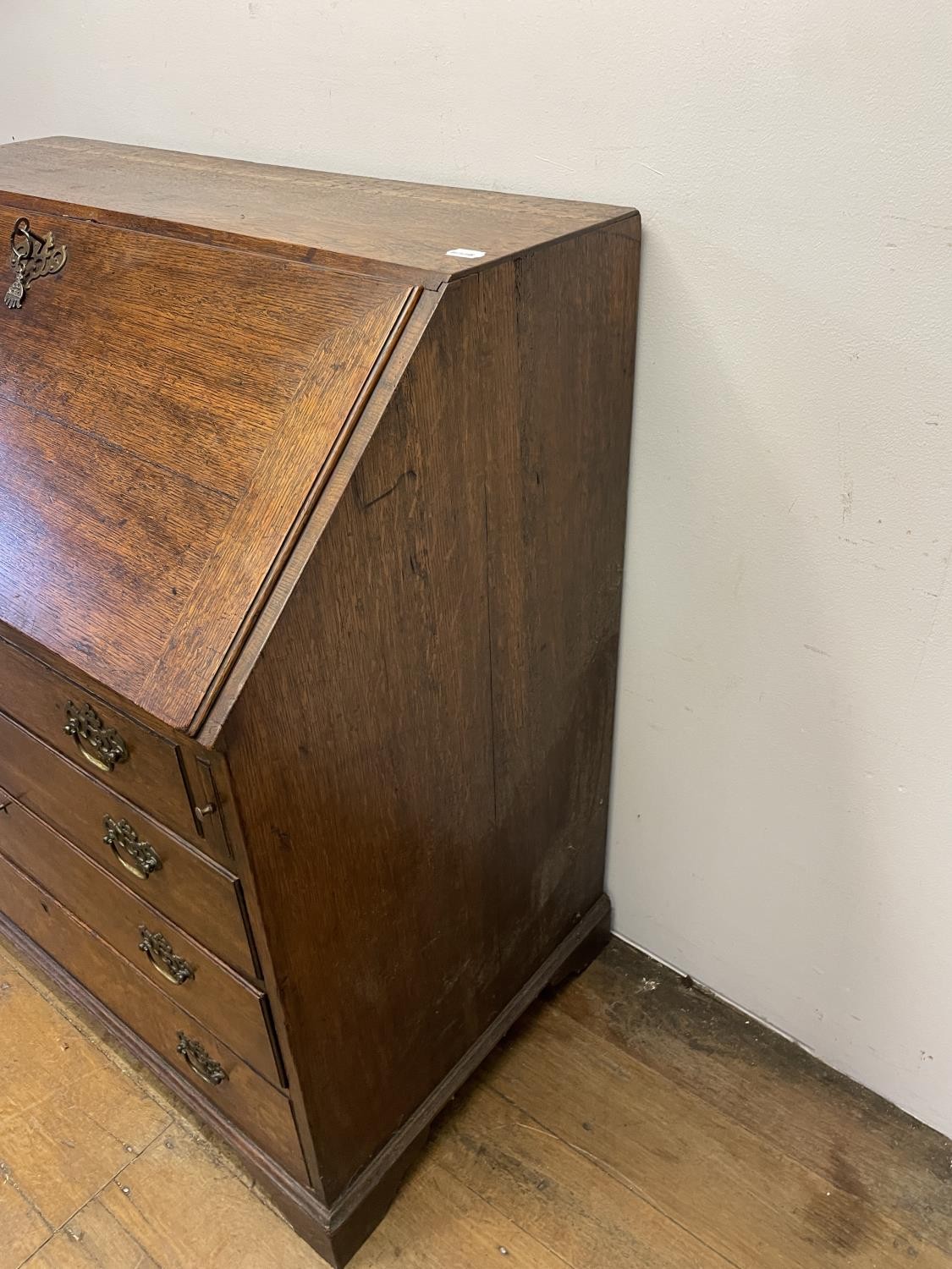 A George III oak bureau, the fall front to reveal a fitted interior, above four graduated drawers, - Image 3 of 9