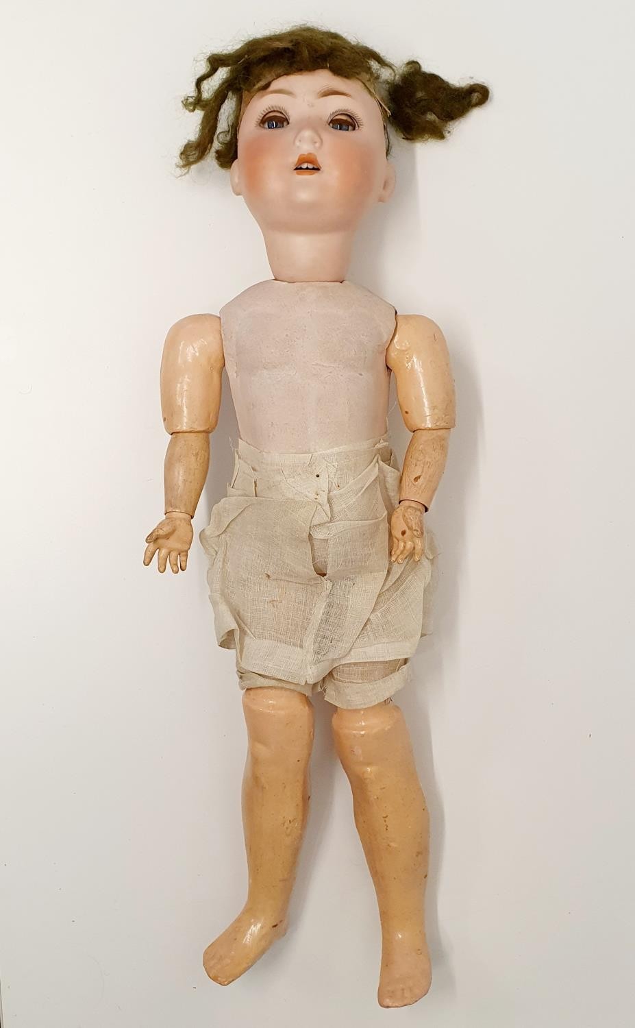 A Simon & Halbig German bisque headed doll, No 1009-6, a composite jointed body, and closing