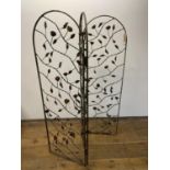 A painted metal three fold wirework screen, decorated roses, each panel, 160 x 50 cm