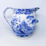 A large 19th century Staffordshire blue and white jug, decorated landscape with ruin, 32 cm high