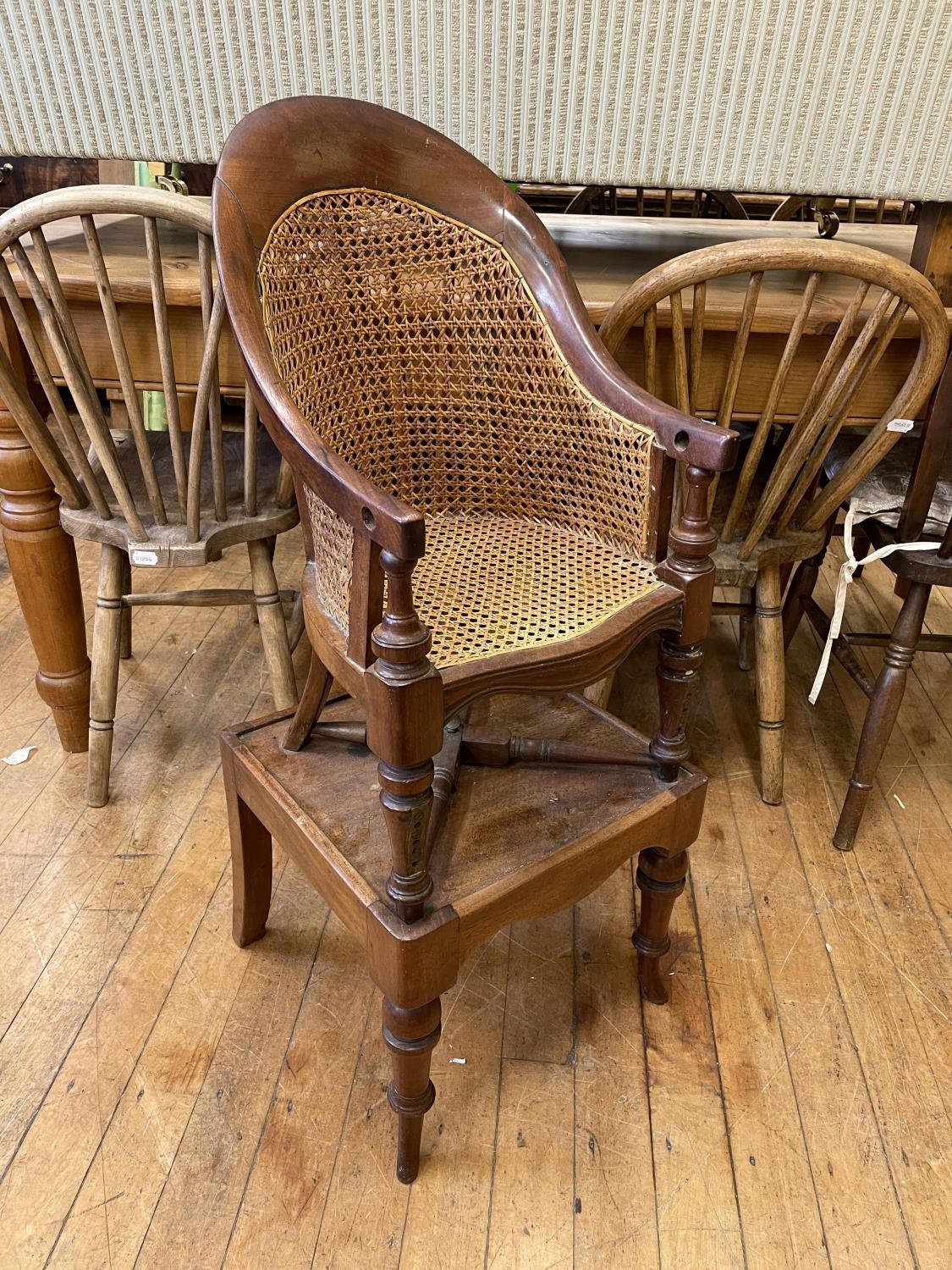 An early 19th century mahogany childs bergere high chair, on a stand