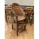 An early 19th century mahogany childs bergere high chair, on a stand