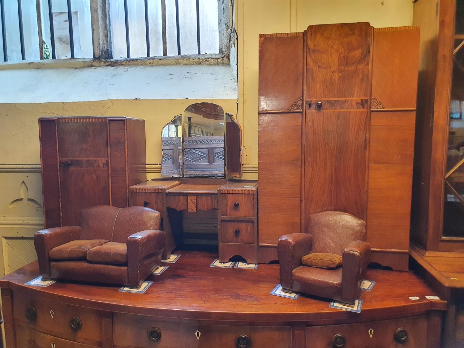 An Art Deco miniature suite of bedroom furniture, comprising two wardrobes, a dressing table, a