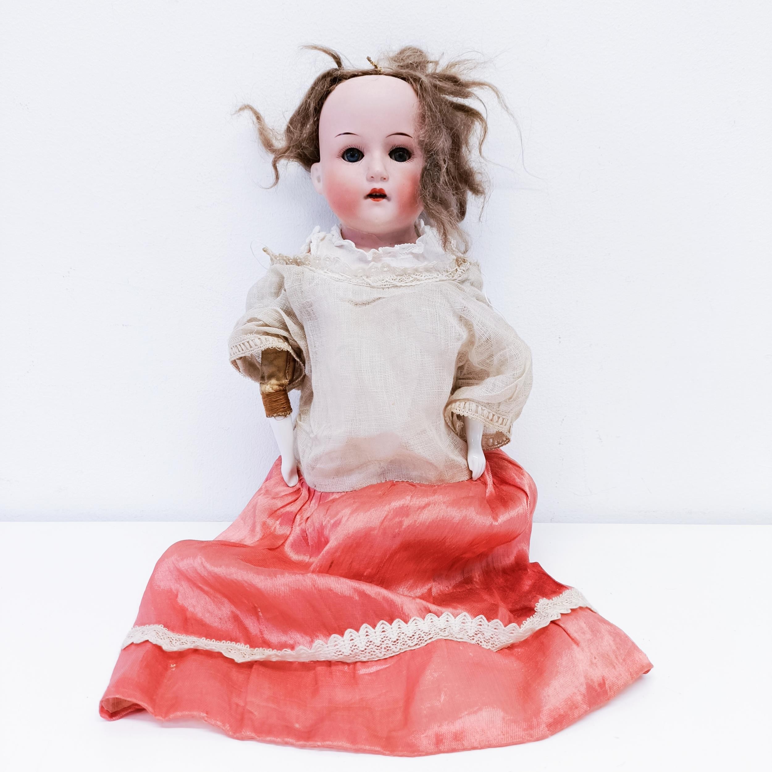 A Heubach bisque headed doll, No 275-/0, with a leather and porcelain body, and millefiori closing